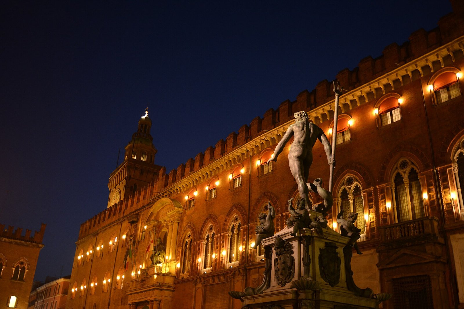 La Fontana del Nettuno a Bologna illuminata davanti a Palazzo d'Accursio